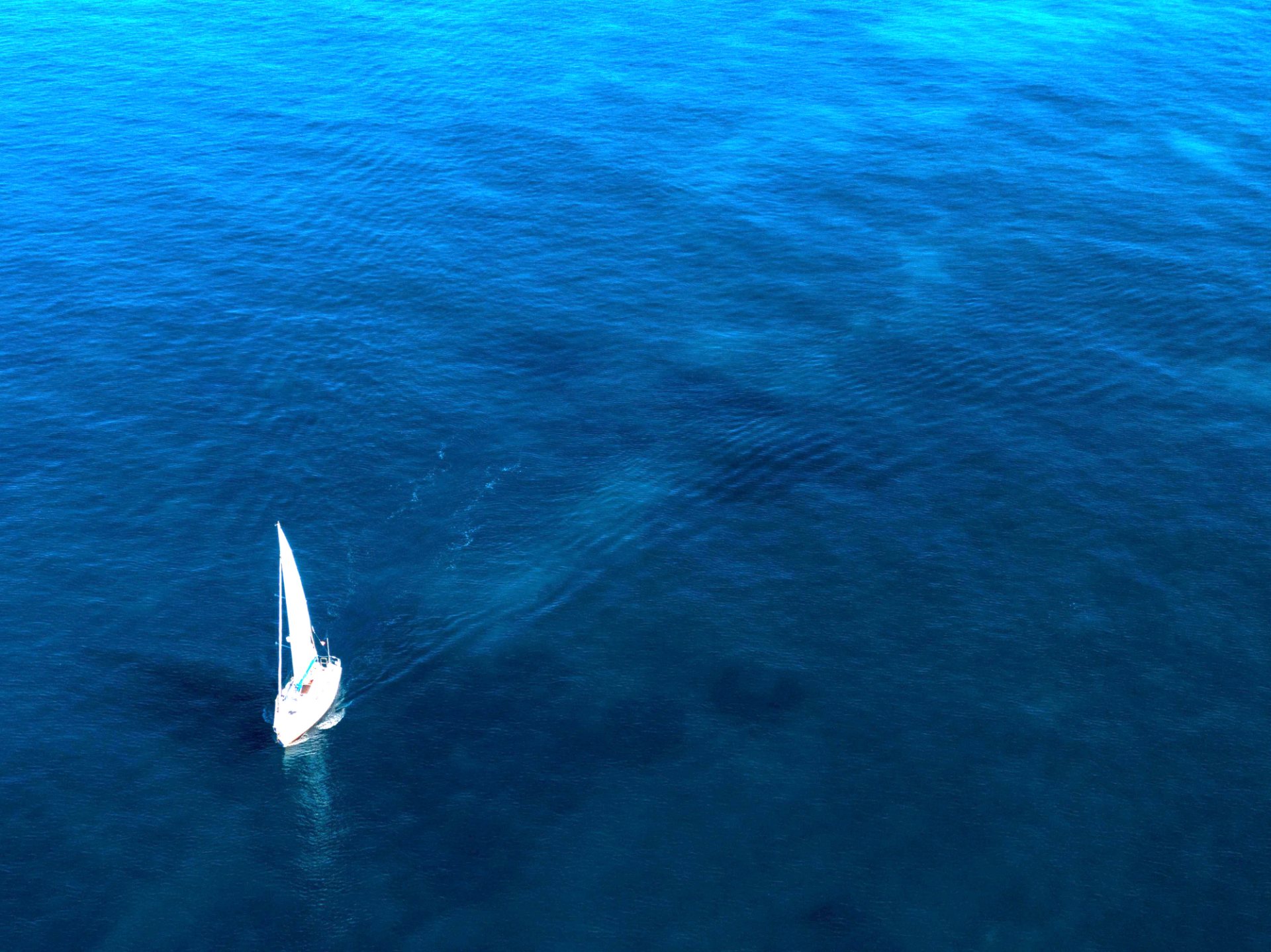 A lone sailboat on open sea